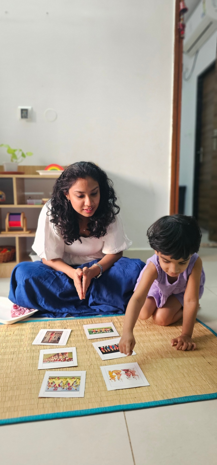 Your host guiding her child through a Montessori activity at home